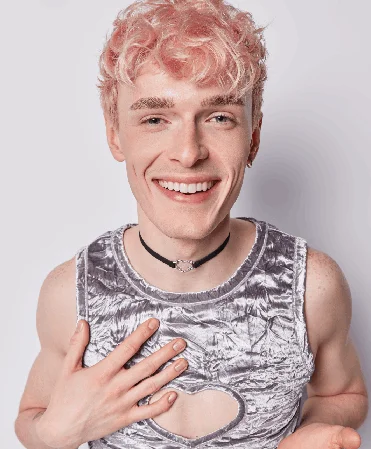 Joyful person with pink hair feeling confident in their body