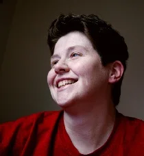 Individual smiling with confidence after gender affirmation